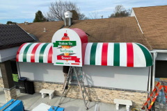 A vibrant, branded canopy wrap installed at a Ritas Italian Ice 