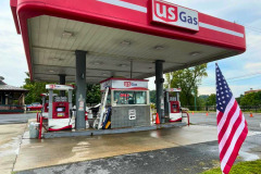 A U.S. Gas station featuring a fully wrapped canopy and matching wrapped fuel pumps, creating a cohesive and branded look.