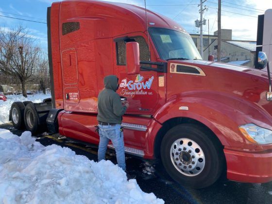 Car wrap with a business logo on a newly painted red truck in Coopersburg